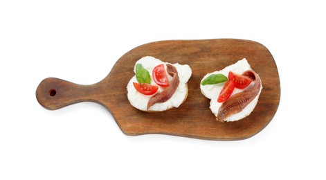 Delicious sandwiches with cream cheese, anchovies, tomatoes and basil on white background, top view