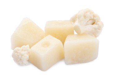 Photo of Frozen cauliflower puree cubes and fresh cauliflower isolated on white