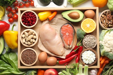 Many different healthy food on white table, flat lay