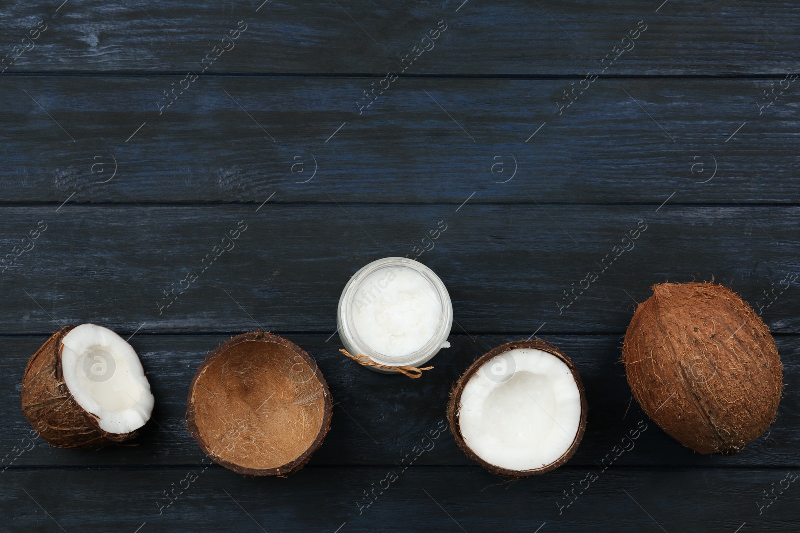 Photo of Flat lay composition with coconut oil on dark wooden table, space for text. Cooking ingredients