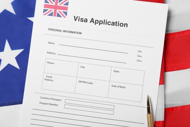 Immigration to USA. Visa application form and pen on flag, flat lay