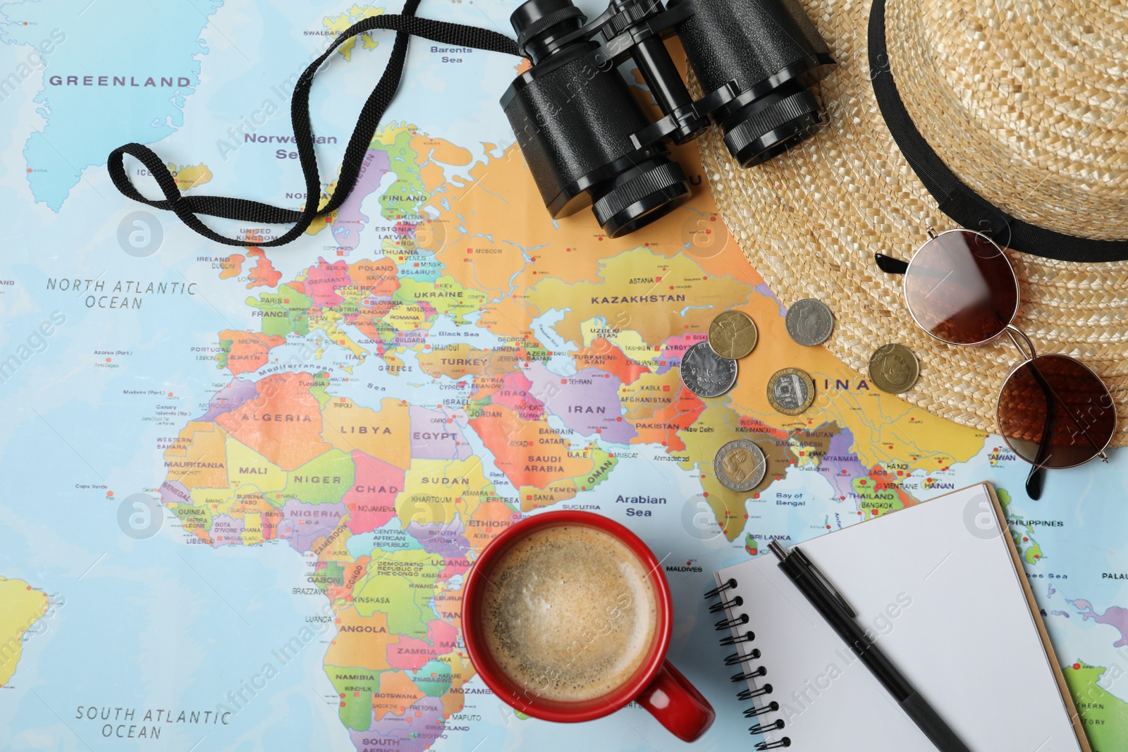 Photo of Flat lay composition with different travel accessories on world map. Planning summer vacation trip