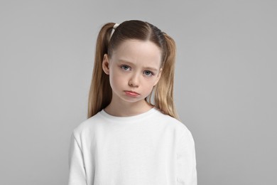 Photo of Portrait of sad girl on light grey background