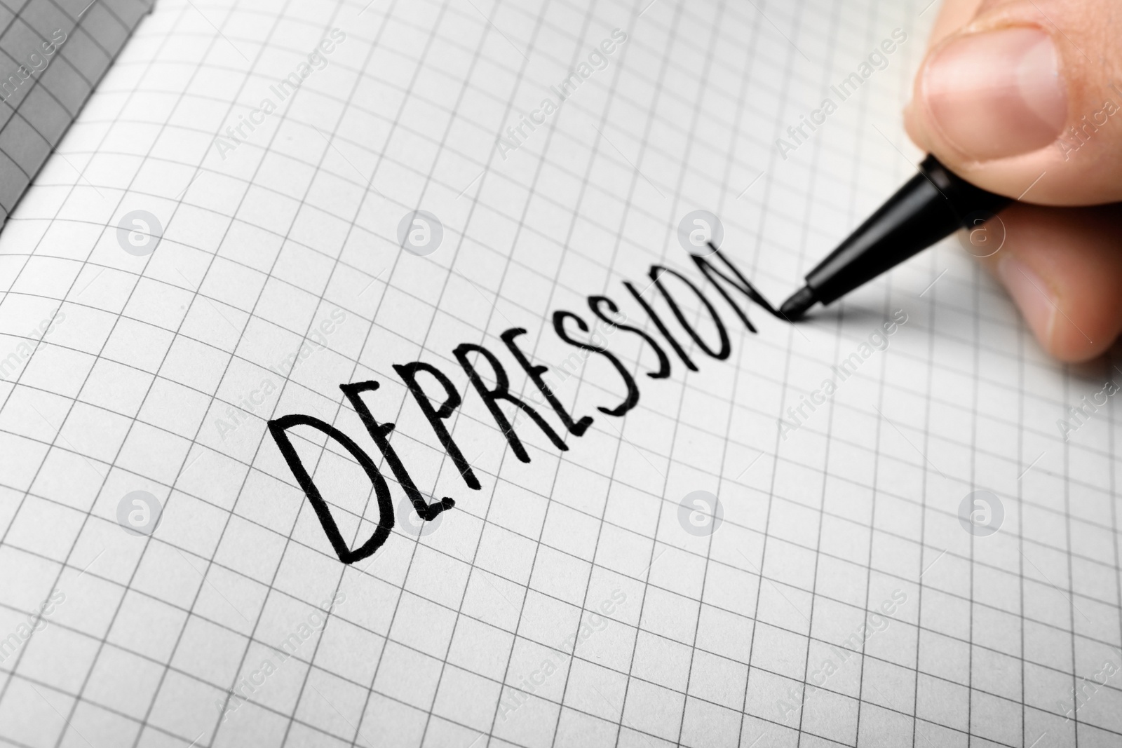 Photo of Woman writing word Depression in notebook, closeup