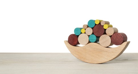 Photo of Wooden balance toy on table against white background, space for text. Children's development