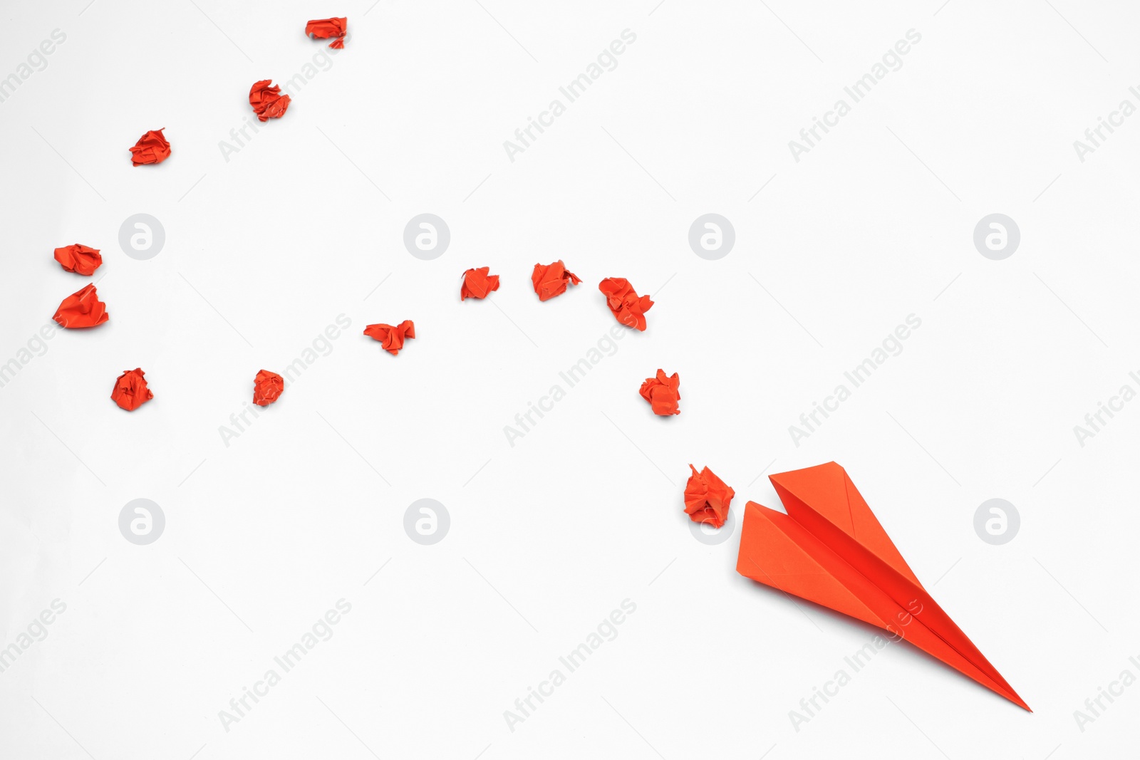 Photo of Flat lay composition with red paper plane on white table