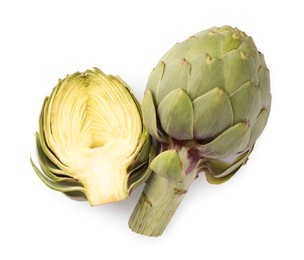 Cut and whole fresh artichokes on white background, top view