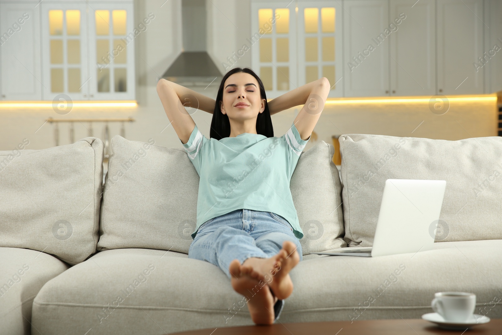 Photo of Young woman relaxing on sofa at home