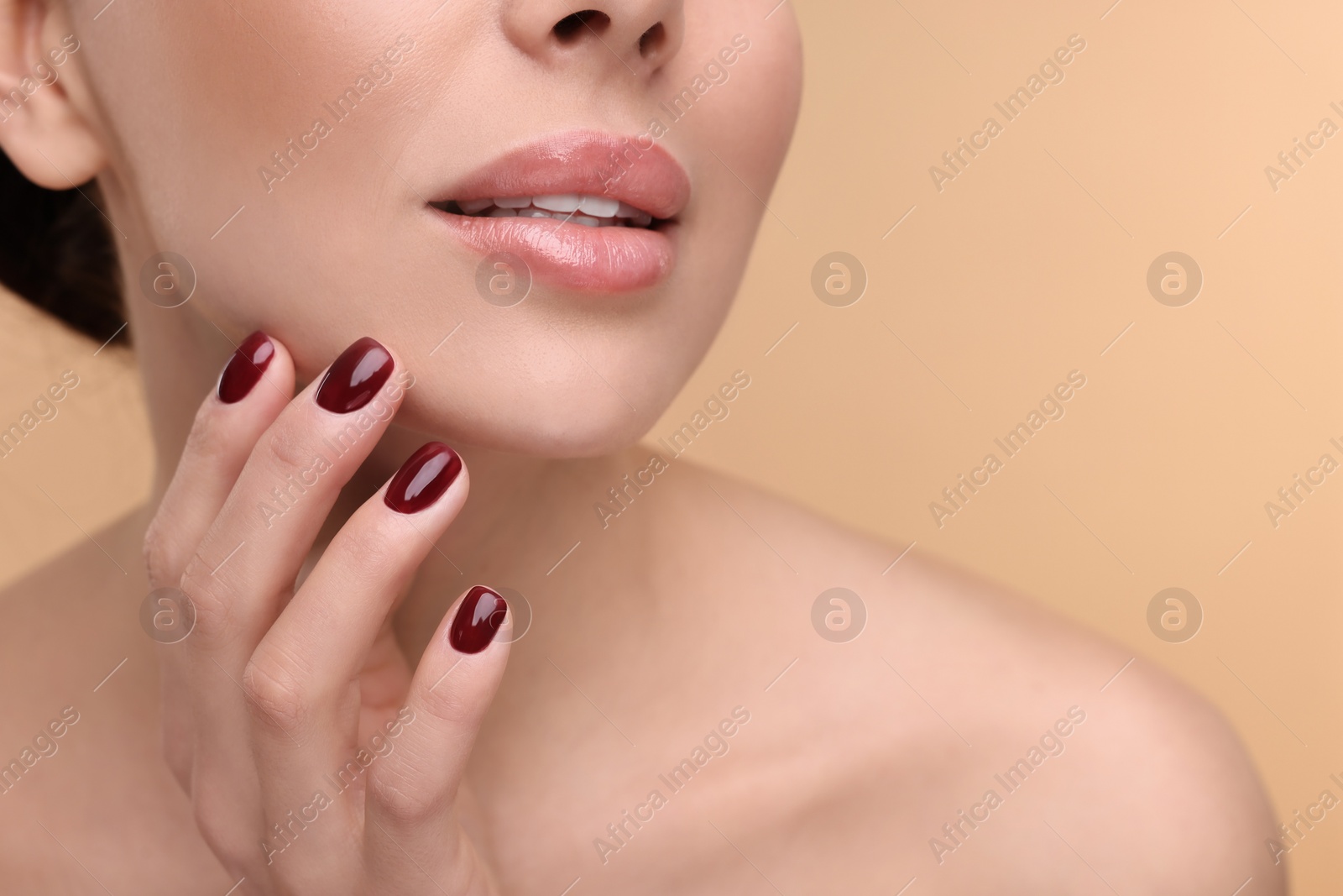 Photo of Woman with beautiful lips on beige background, closeup