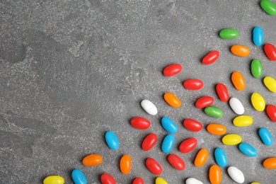 Flat lay composition with jelly beans on stone background. Space for text