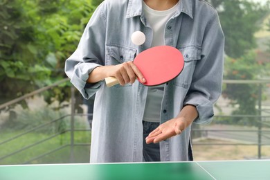 Woman playing ping pong indoors, closeup view