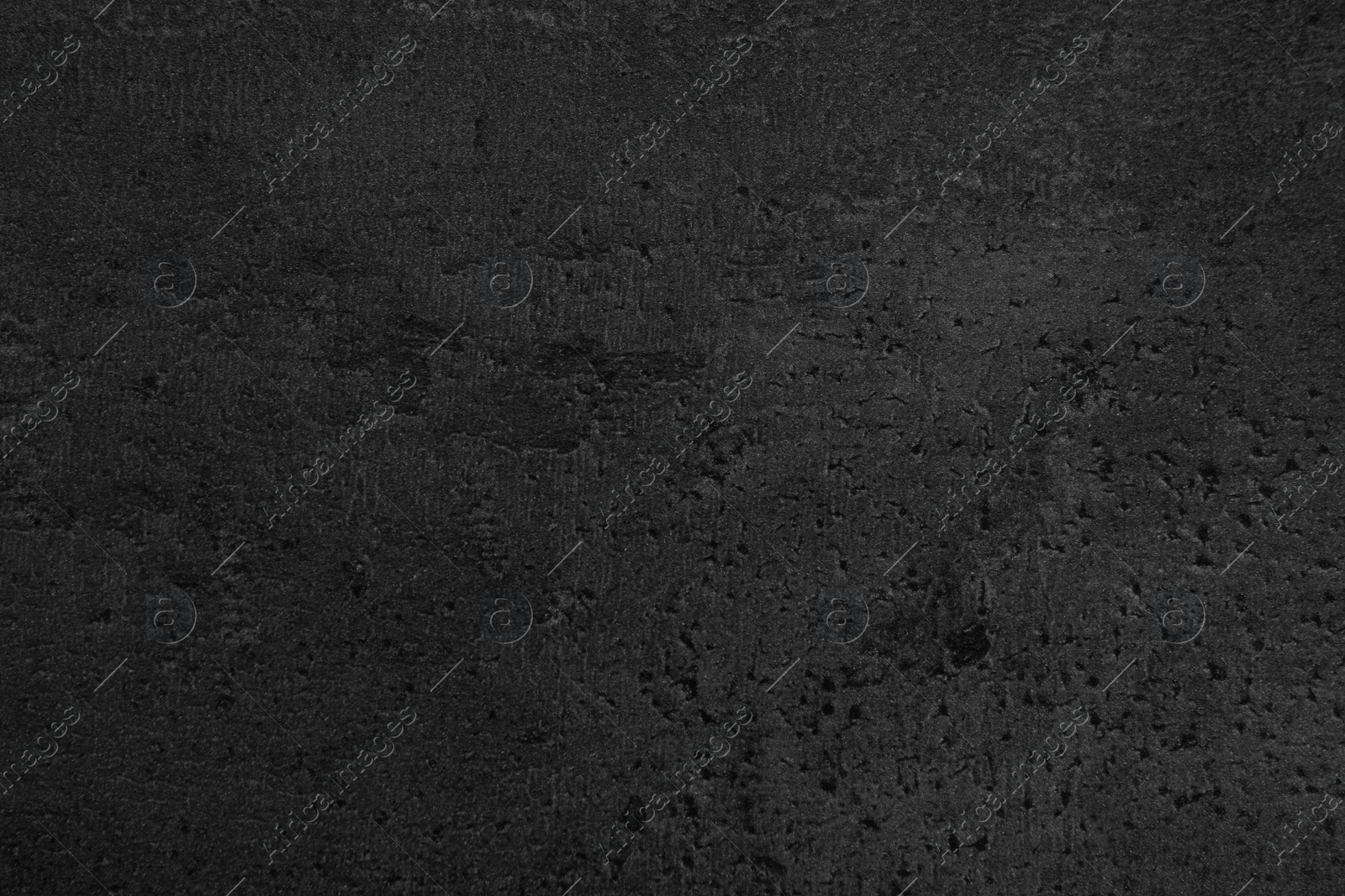 Photo of Texture of black stone surface as background, closeup