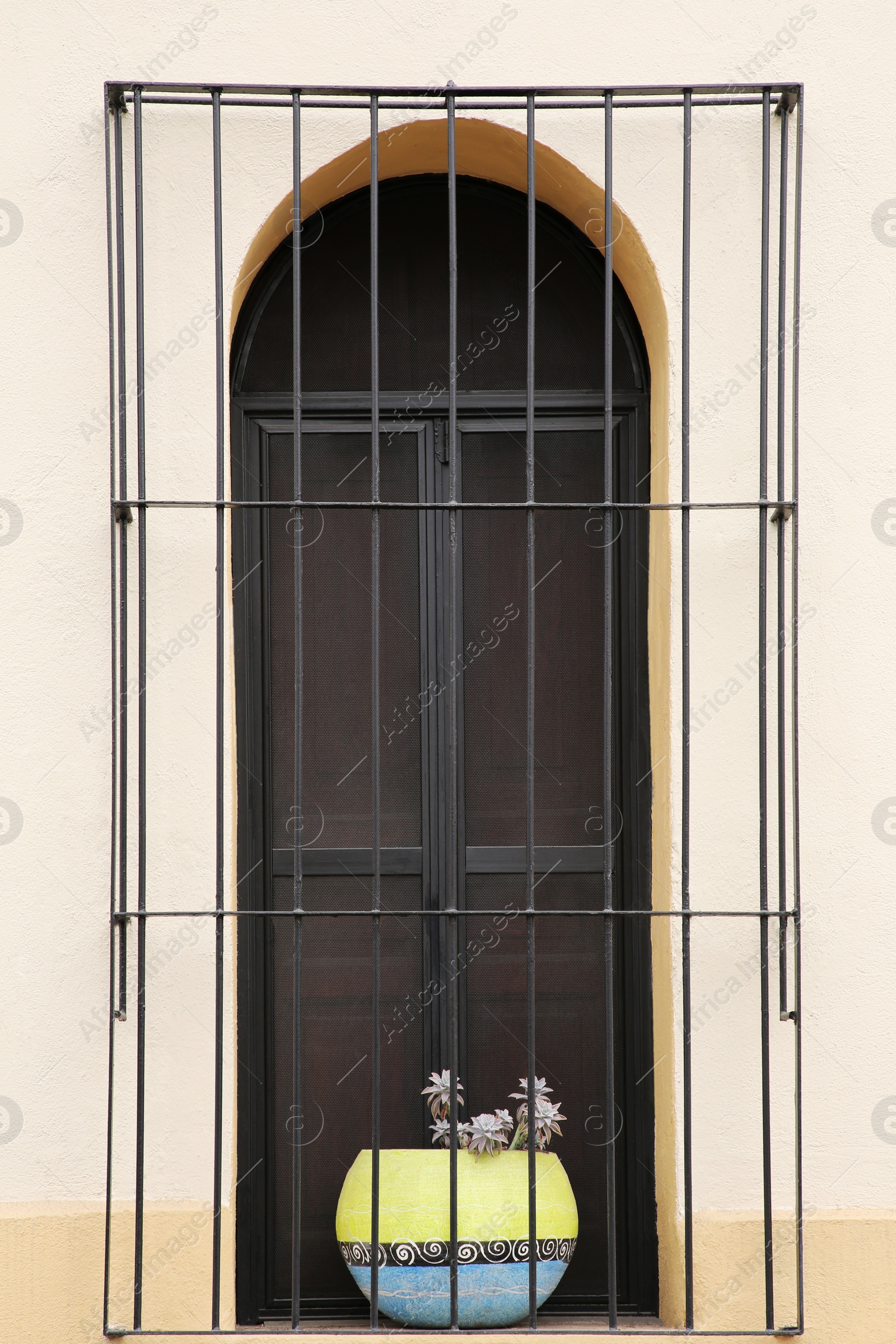 Photo of Building with beautiful window and steel grilles