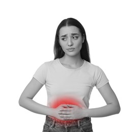 Woman suffering from abdominal pain on white background. Black and white effect with red accent