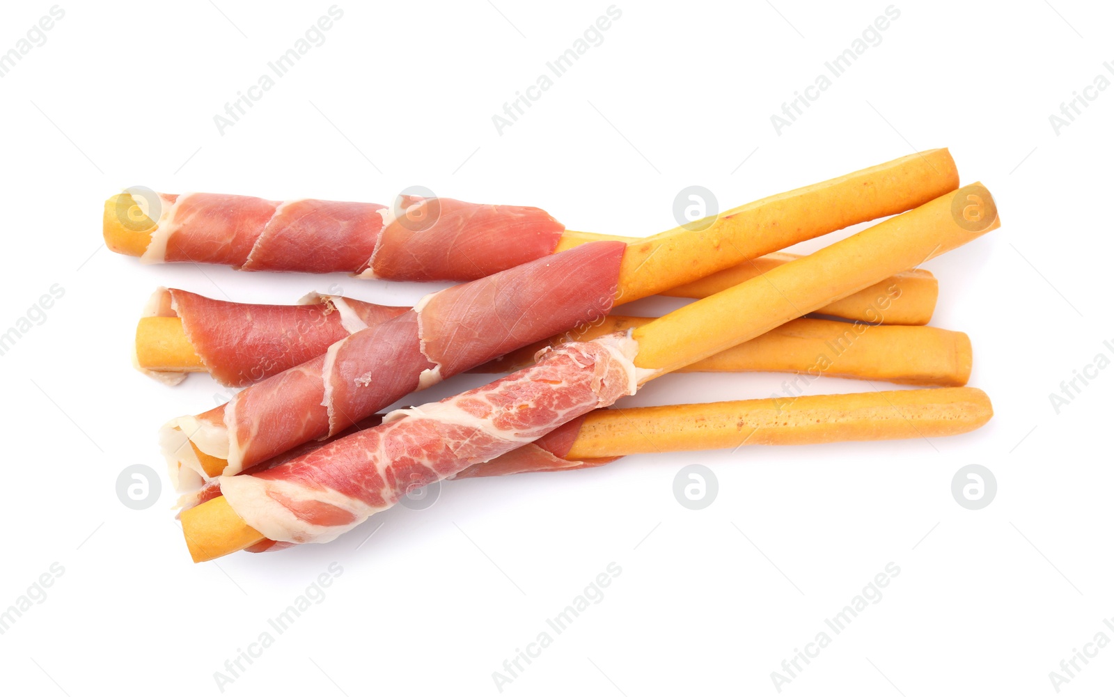 Photo of Delicious grissini sticks with prosciutto on white background, top view