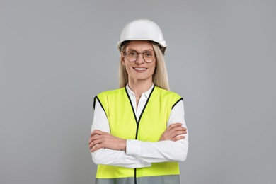 Photo of Engineer in hard hat on grey background