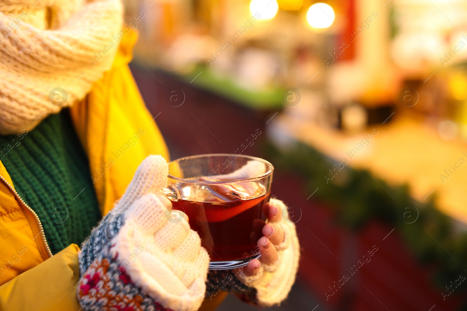 Photo of Woman with mulled wine at winter fair, closeup