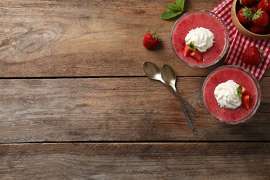 Photo of Delicious strawberry mousse with mint on wooden table, flat lay. Space for text