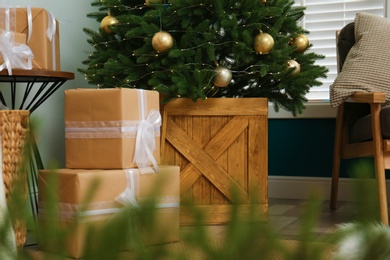 Beautiful decorated Christmas tree and gift boxes in room