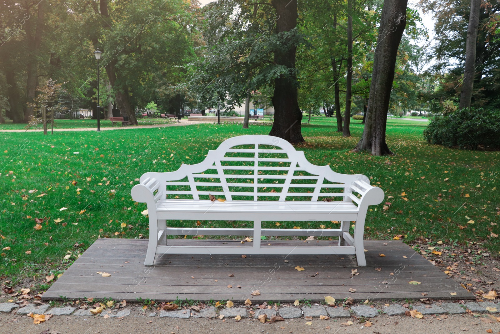 Photo of Beautiful white bench in public city park