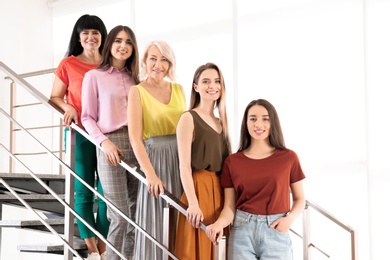 Photo of Group of ladies on stairs indoors. Women power