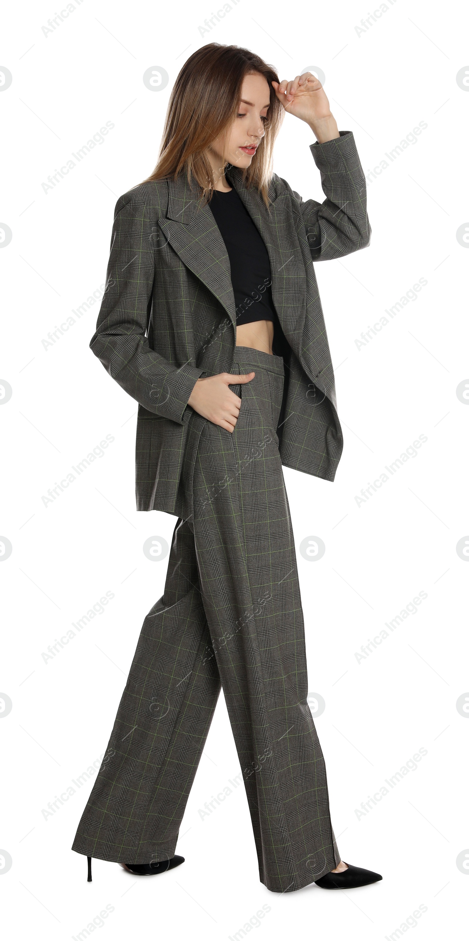 Photo of Full length portrait of beautiful young woman in fashionable suit on white background. Business attire