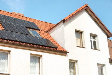 Photo of House with installed solar panels on roof. Alternative energy