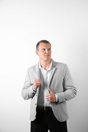 Photo of Handsome young man in suit on white background