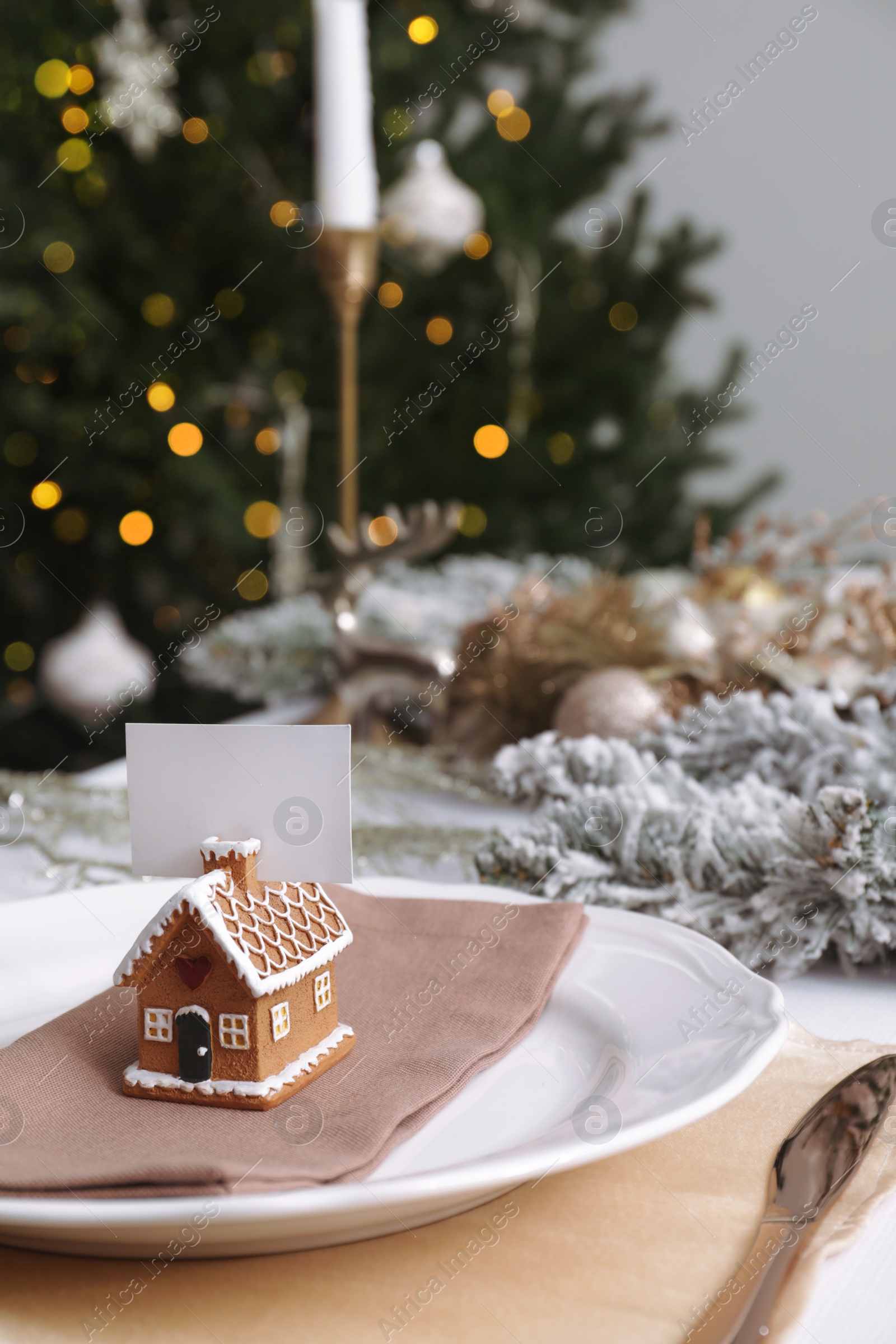 Photo of Beautiful festive place setting with blank card and stylish decor for Christmas dinner on white table. Space for text