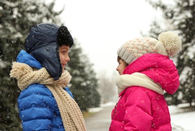 Cute little children outdoors on snowy day