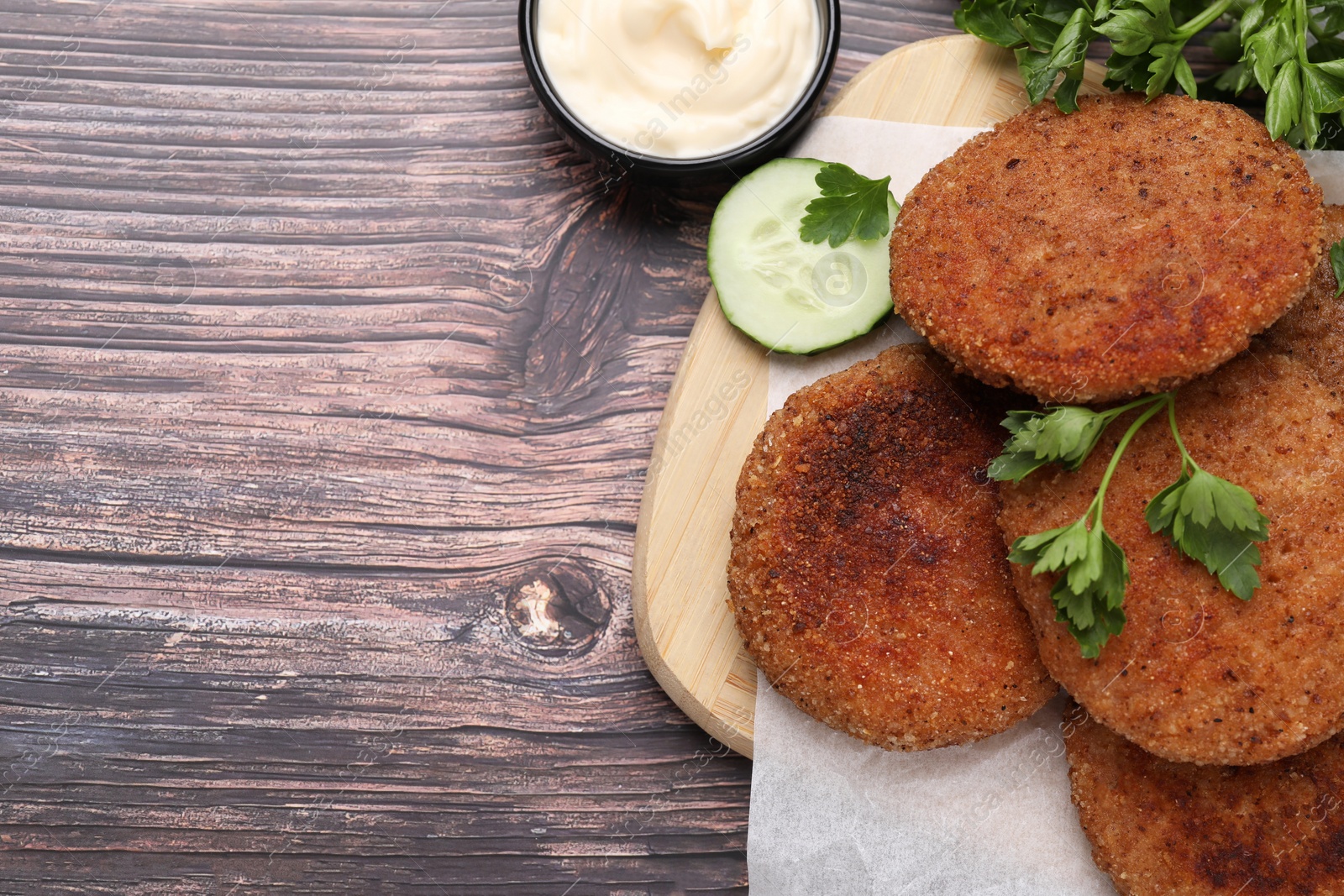 Photo of Tasty vegan cutlets served on wooden table, flat lay. Space for text