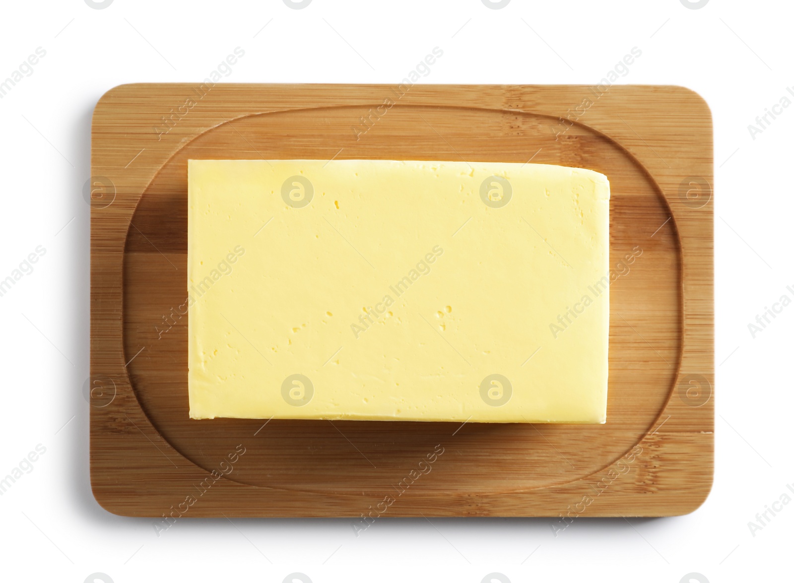 Photo of Wooden board with block of fresh butter on white background, top view