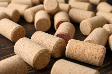 Photo of Many corks of wine bottles on wooden table, closeup