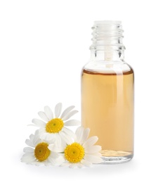 Photo of Chamomile flowers and cosmetic bottle of essential oil on white background