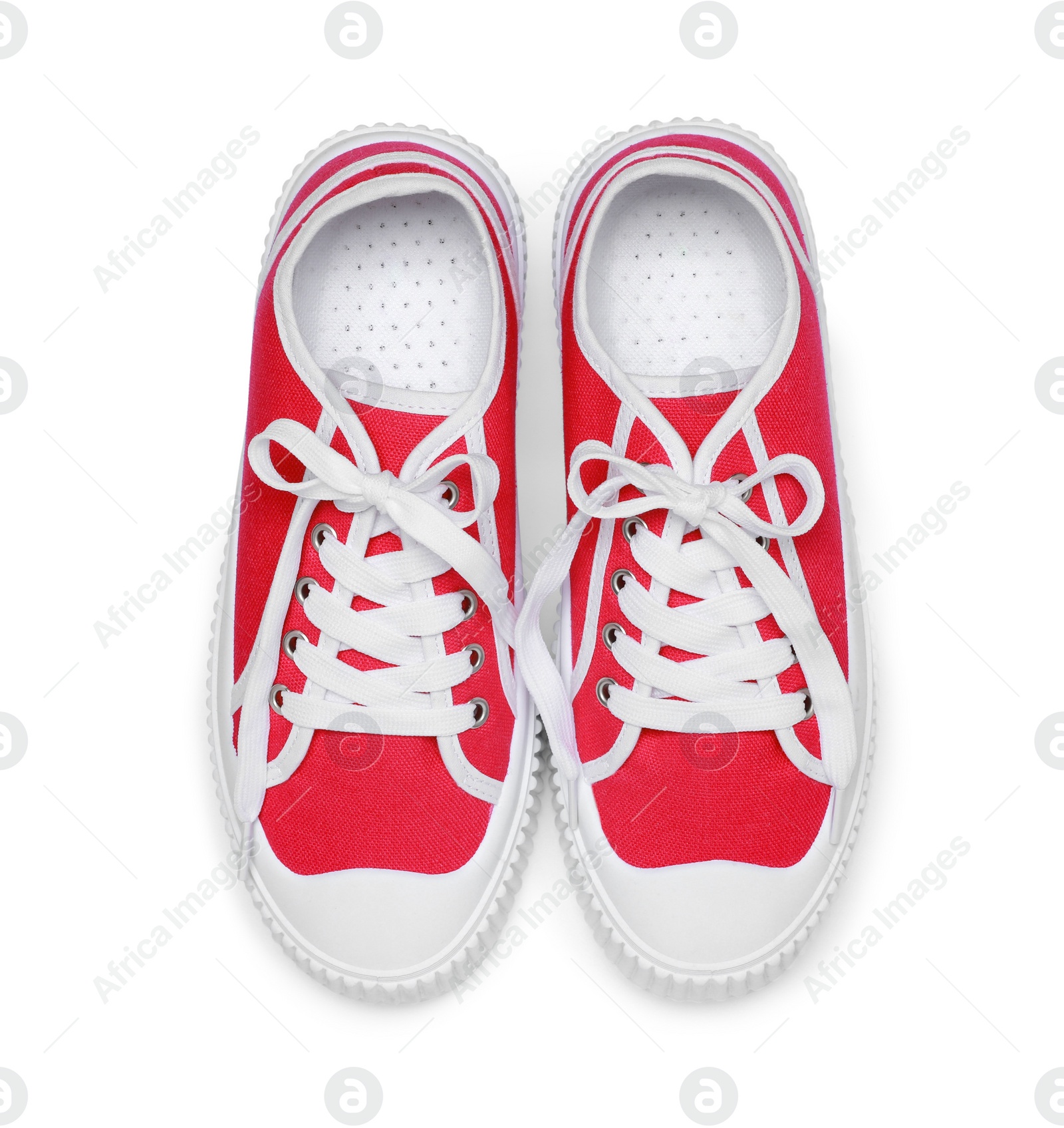 Photo of Pair of red classic old school sneakers isolated on white, top view