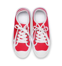 Pair of red classic old school sneakers isolated on white, top view