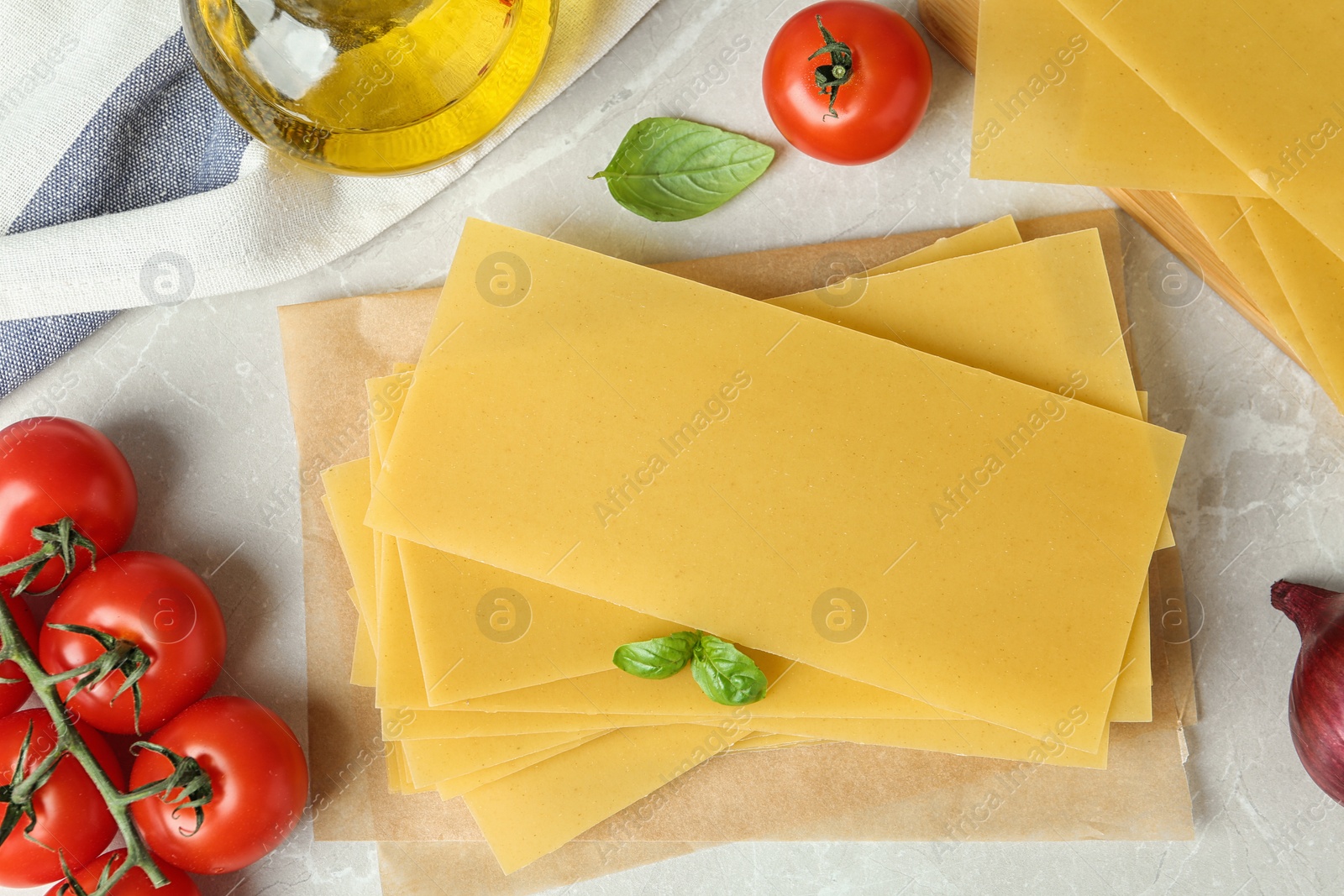 Photo of Flat lay composition with uncooked lasagna sheets on marble table