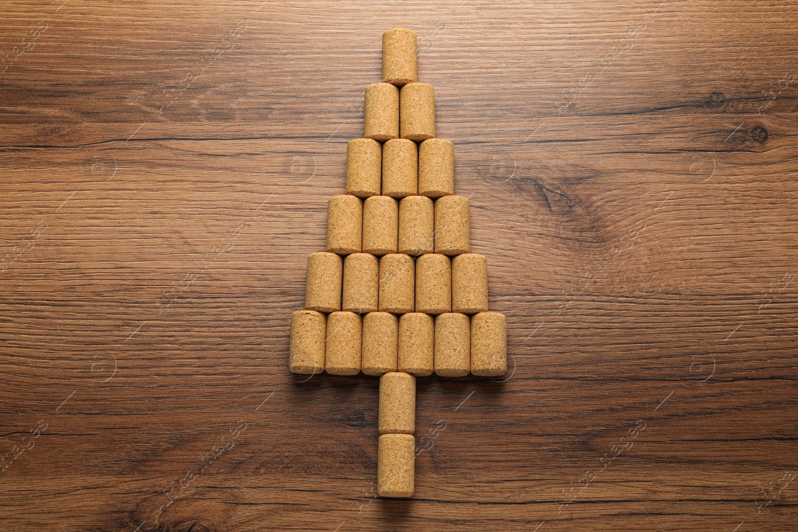 Photo of Christmas tree made of wine corks on wooden table, top view