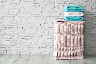 Stack of clean towels on wicker basket