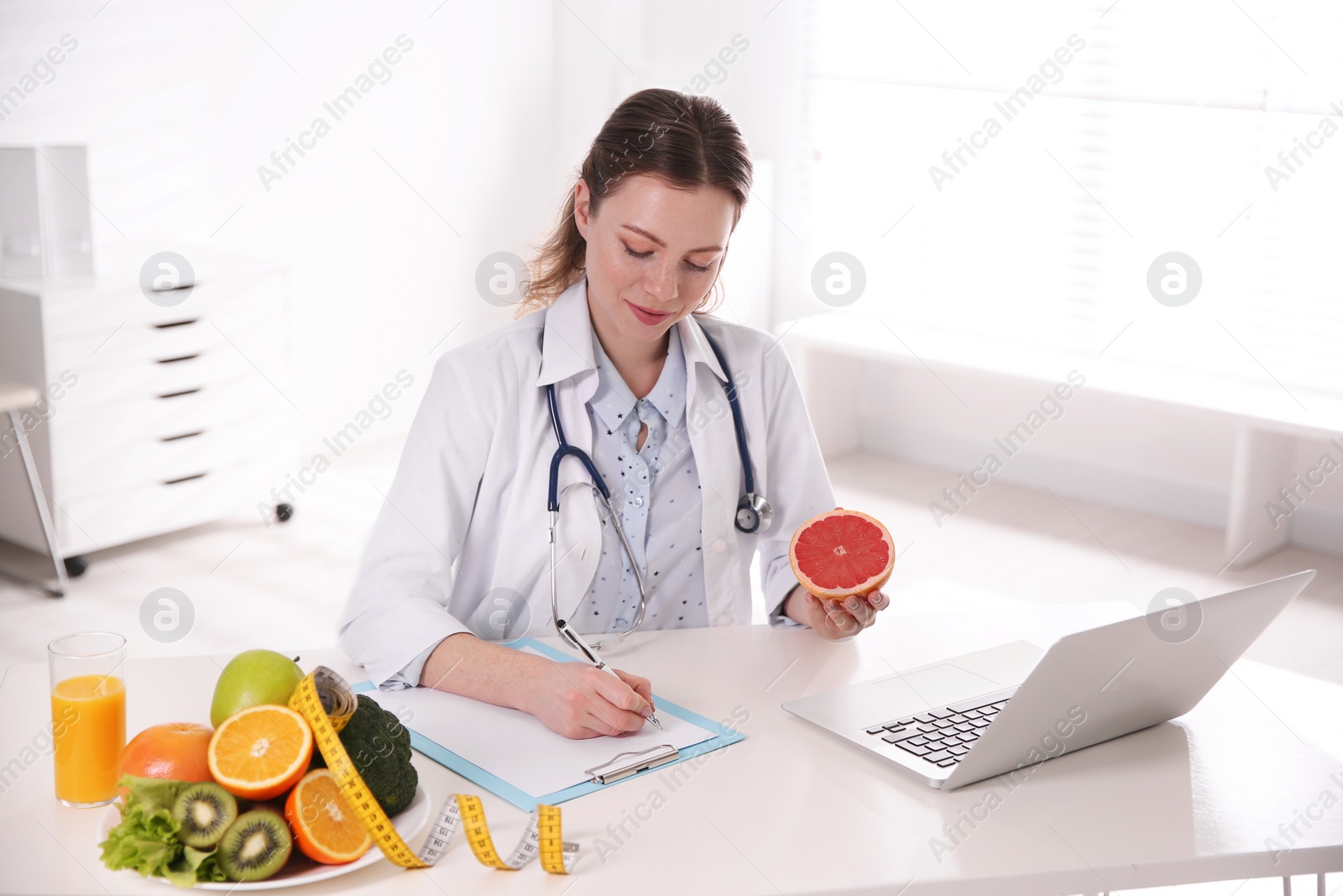 Photo of Female nutritionist working at desk in office