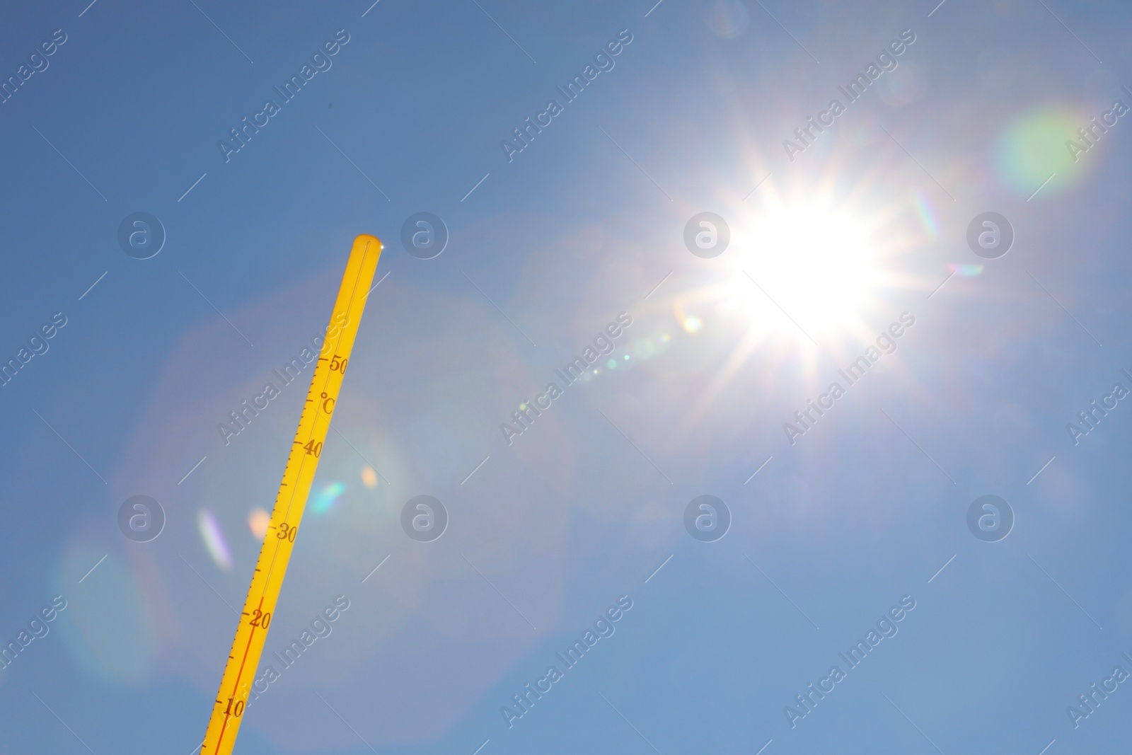 Photo of Weather thermometer against blue sky, space for text