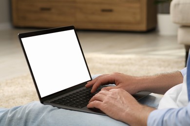 Photo of Man using laptop at home, closeup view