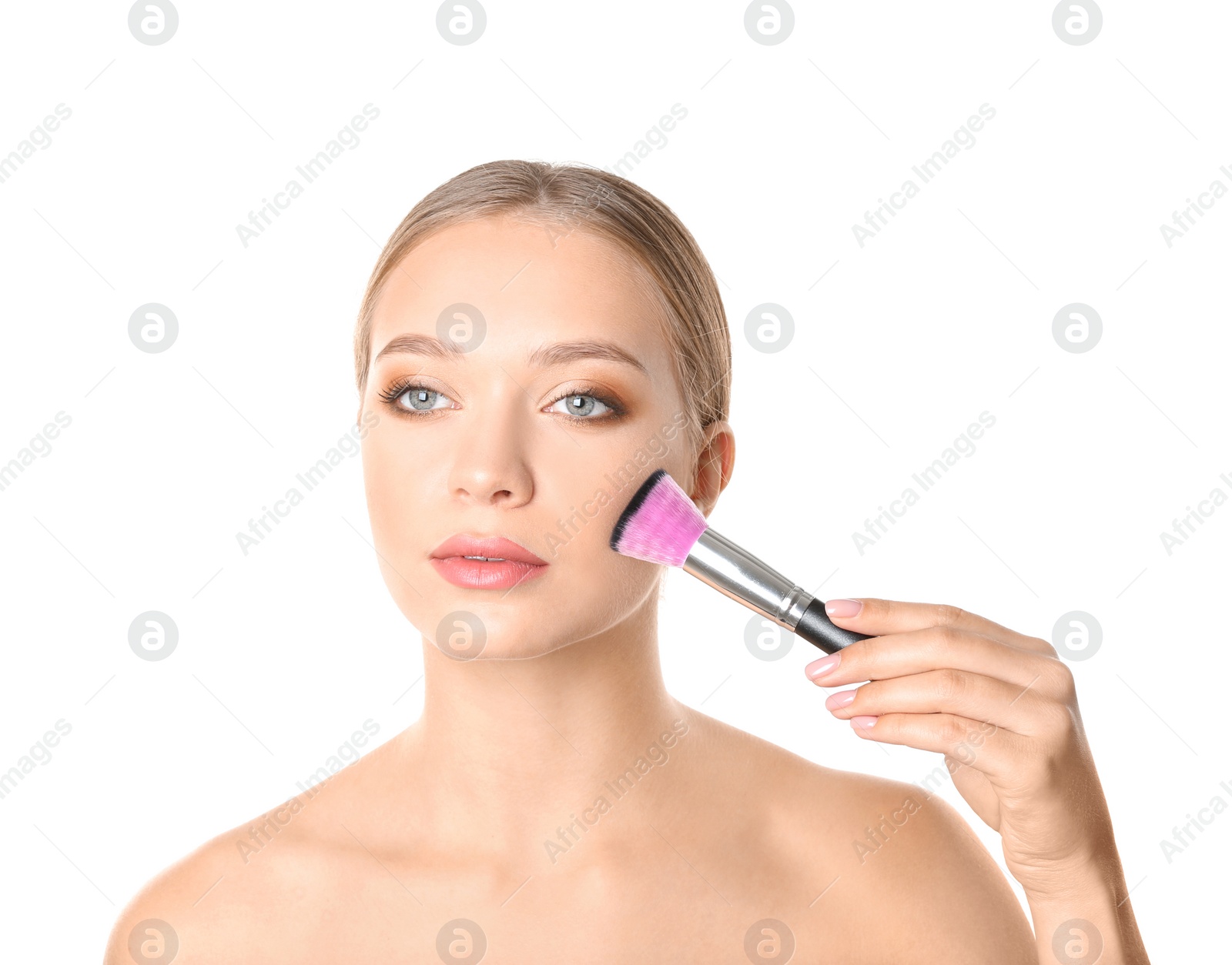 Photo of Portrait of beautiful young woman with makeup brush on white background