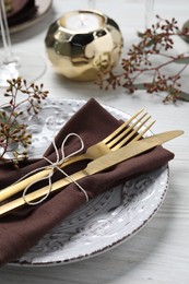 Photo of Stylish table setting with cutlery and eucalyptus leaves