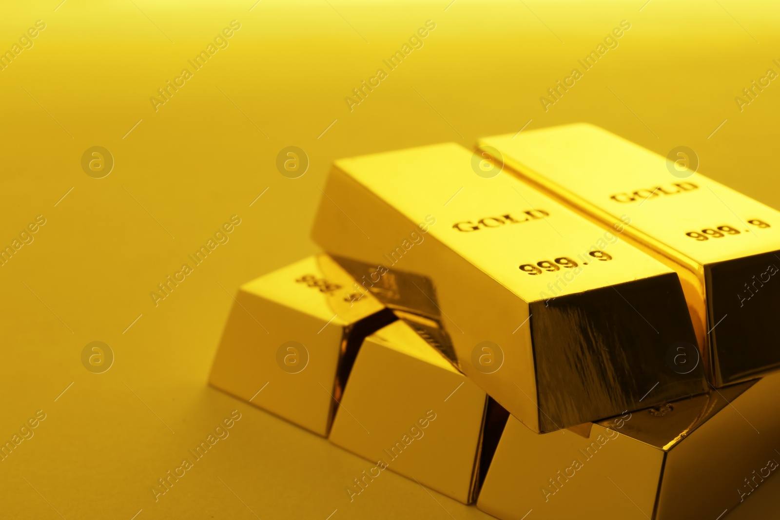 Photo of Precious shiny gold bars on color background