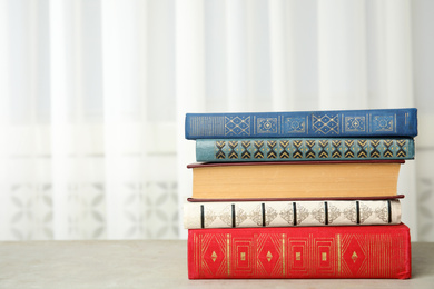 Collection of different books on table indoors. Space for text