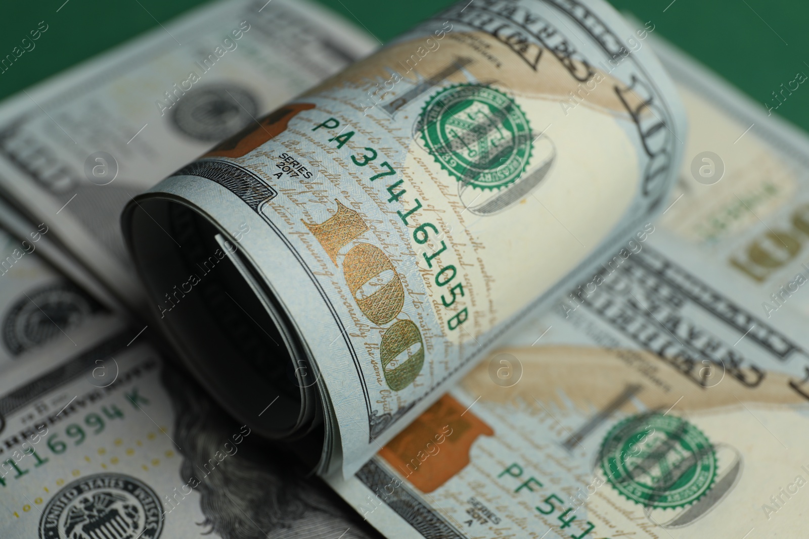 Photo of Money exchange. Dollar banknotes on table, closeup