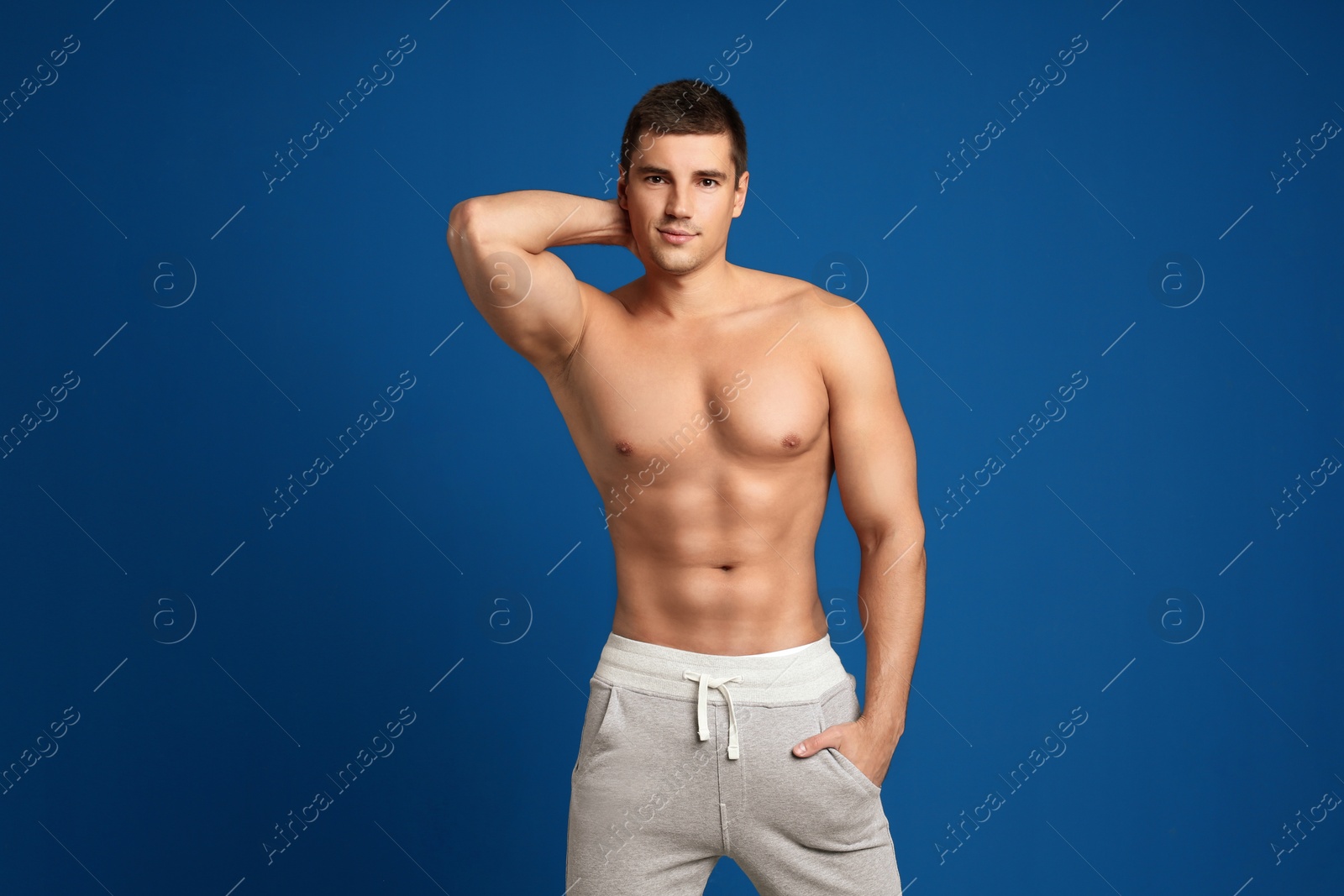 Photo of Man with sexy body on blue background