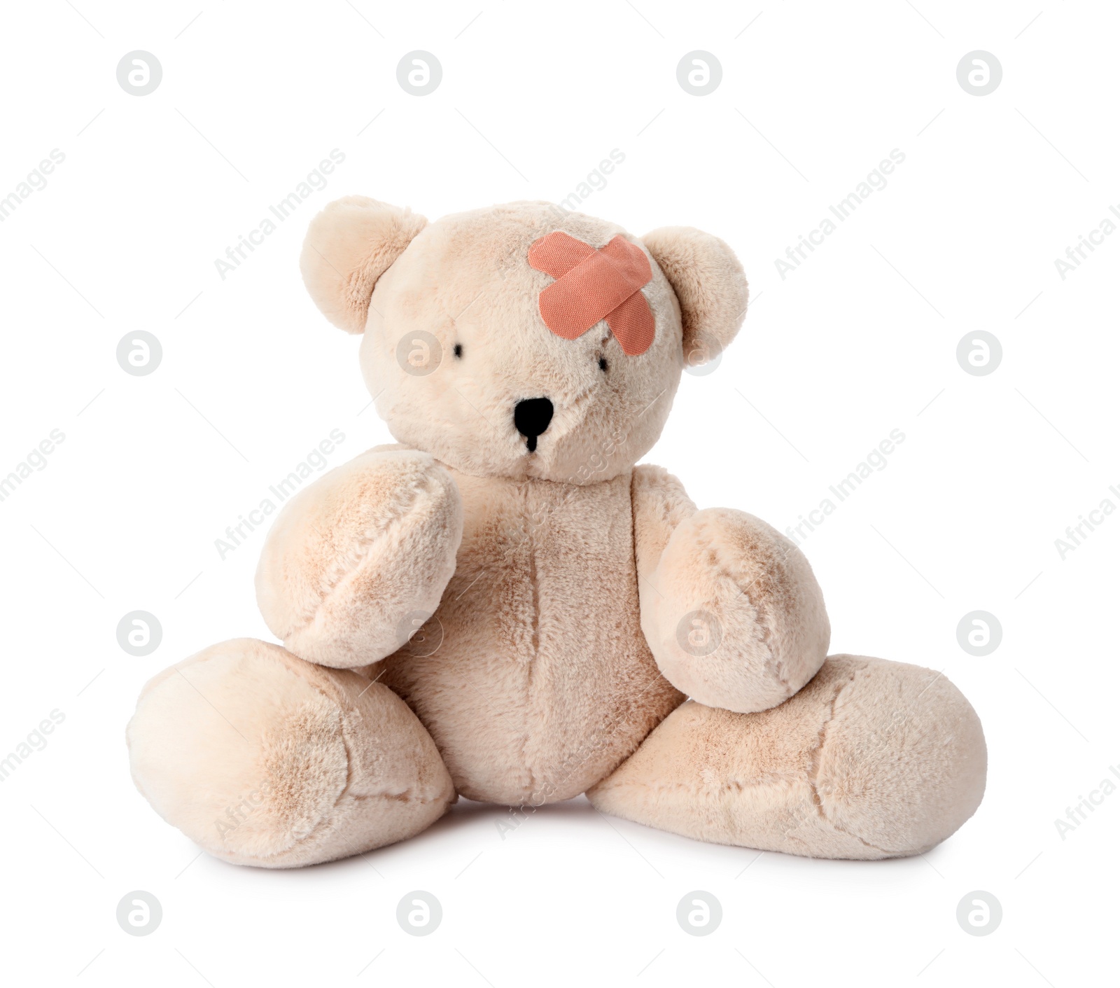 Photo of Toy Teddy bear with sticking plasters isolated on white