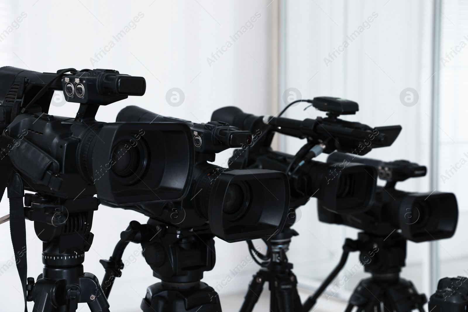 Photo of Modern video cameras indoors. Professional media equipment for broadcasting event